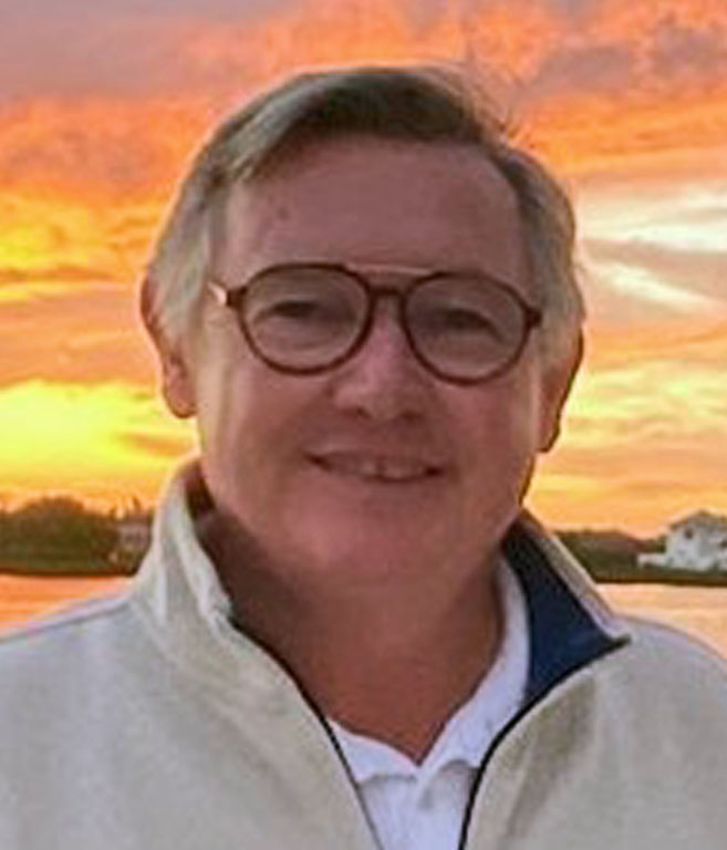A portrait of a man with a sunset background