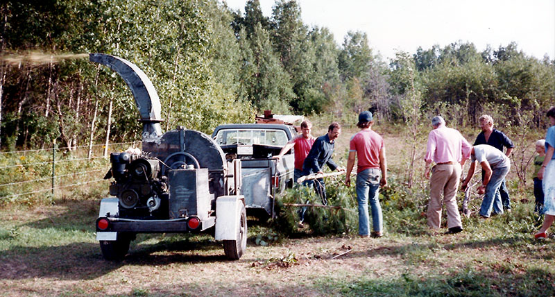 The Bandit Industries team gathers to test and refine the original Brush Bandit woodchipper.