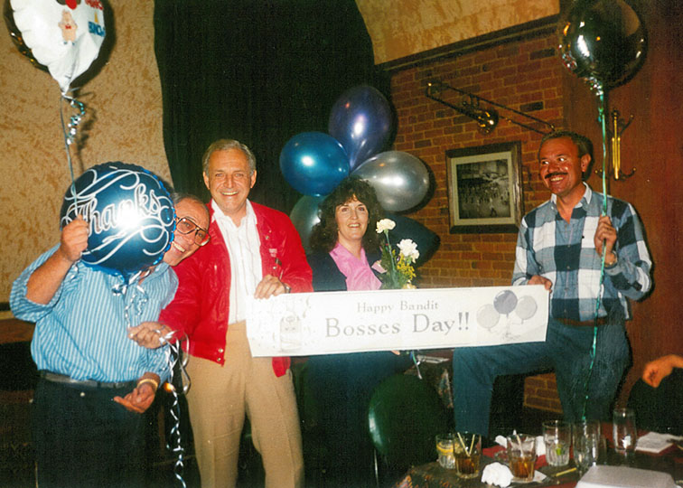 Partners (from left) Mike, Dennis, Dianne, and Jerry take a moment to celebrate during a company event. 