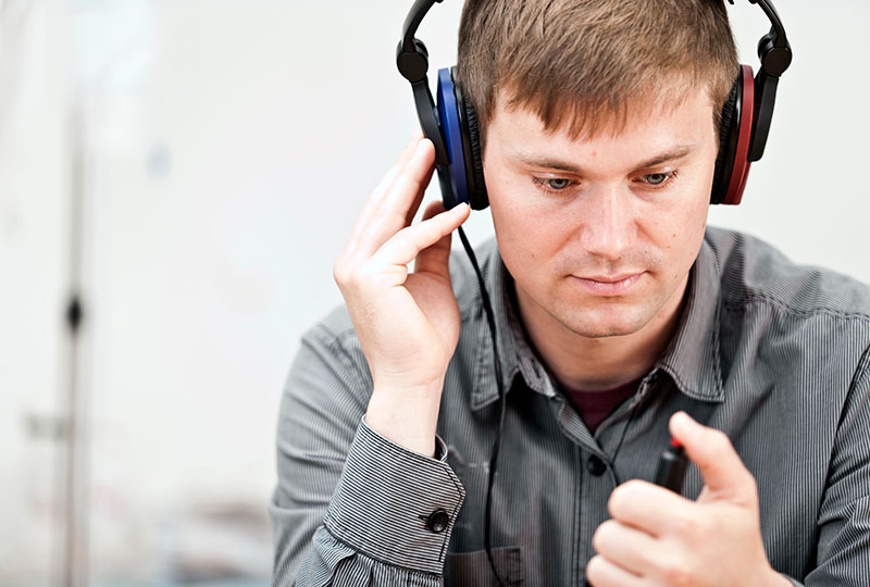 A person with headphones on taking a hearing test.