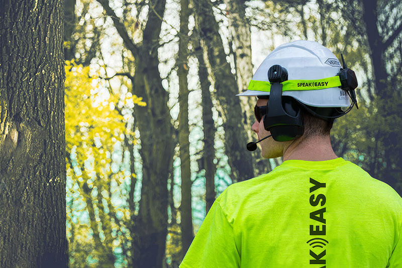 A tree worker communicates with this crew via wireless microphone and headphones.