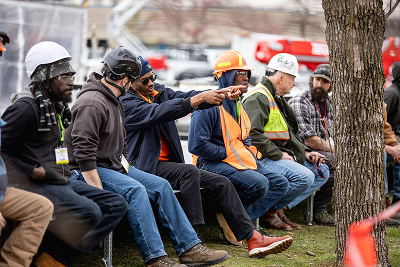 A group of tree workers viewing a tree care demonstration at ArborEXPO.